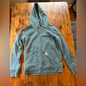 Woman’s forest green Carhartt sweater